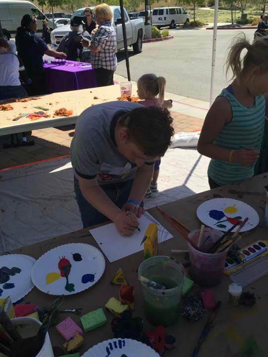A man is painting with children