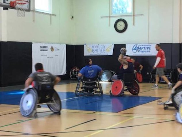 A group of people in wheelchairs playing frisbee.
