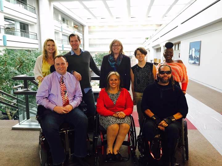 A group of people in wheelchairs posing for the camera.